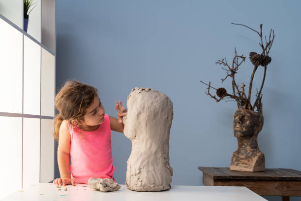istock Elementary Preschooler Girl Making Clay Sculpture 1328022306