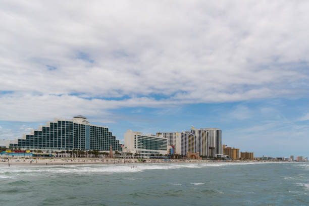istock People on the beach with hotels in the background 1328023527
