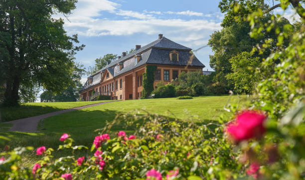LIEPUPE, LATVIA - APRIL 13, 2019: Liepupes Muiza manor in beautiful sunny Spring weather with blue sky and clouds - Warm