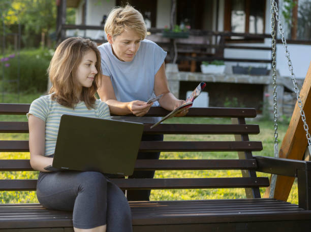 istock Mother and daughter having fun shopping online 1328024342