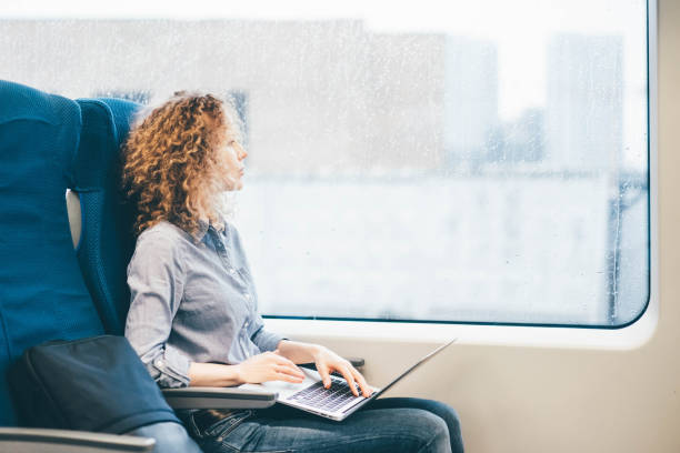 istock Freelancer girl working with laptop in the train. 1328024427