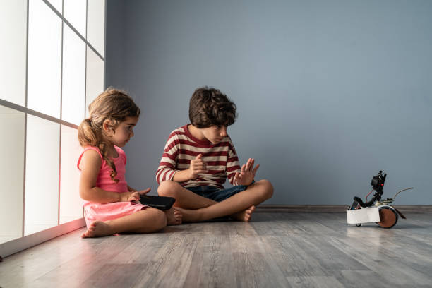 istock Brother And Sister Playing With Toy Robot 1328025658