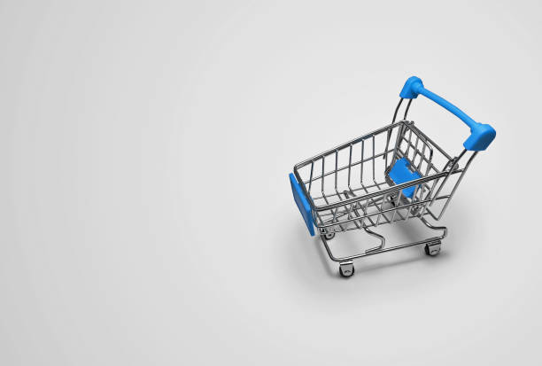 istock A miniature empty grocery basket in blue on a light gray background with space for text. 1328027842