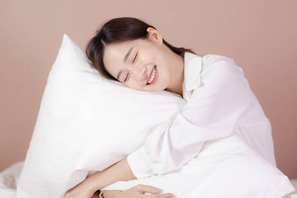 istock Cute woman sitting on her sofa with pillow in hands 1328028508
