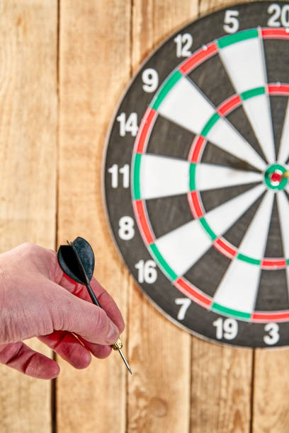 istock Darts game. Throwing darts at the target 1328029895