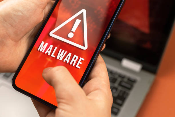 istock Woman use the mobile phone with malware software, cyber hacking attack and crime concept 1328033883