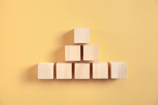 istock Wooden cubes on yellow background. 1328034564