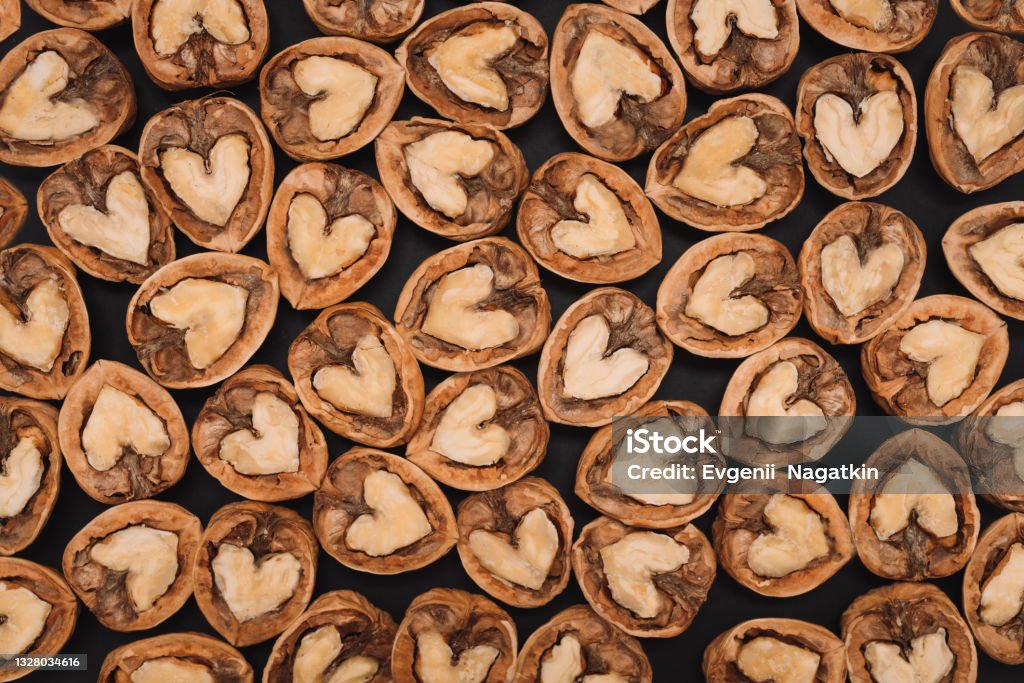 Walnuts. Background of fresh walnuts. Abstract walnuts heap pattern background. Natural food in-shell nuts. Natural walnut background pattern texture. Walnut Tree Stock Photo