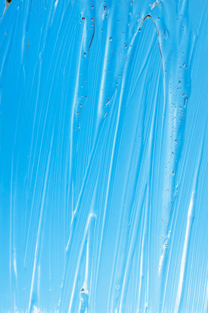 istock Liquid cosmetic gel on blue background. Hand antibacterial gel. 1328035914