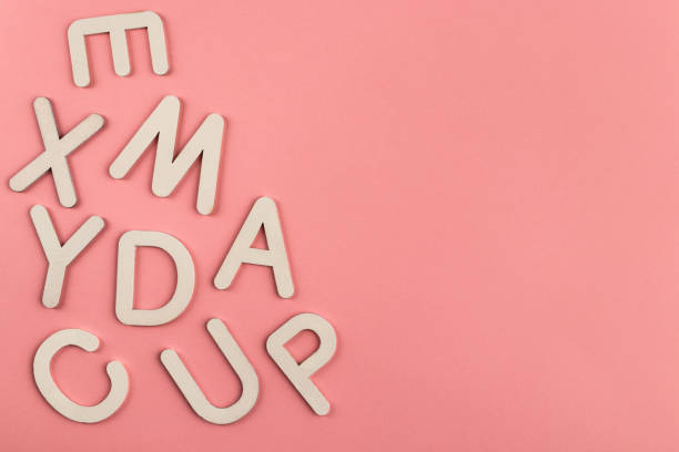istock Wooden alphabet letters on pink paper background. 1328038123