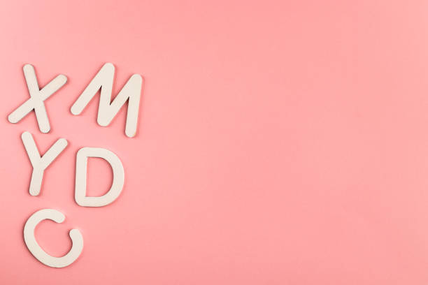 istock Wooden alphabet letters on pink paper background. 1328038126