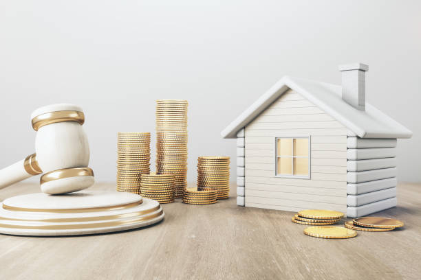 White house with golden coin stacks and gavel on concrete and wooden background. Divorce and property division concept. 3D Rendering. stock photo