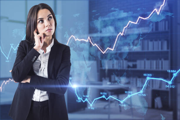 istock Thoughtful young businesswoman with abstract glowing forex chart in blurry office interior. Economy and fund management concept. Double exposure. 1328041876