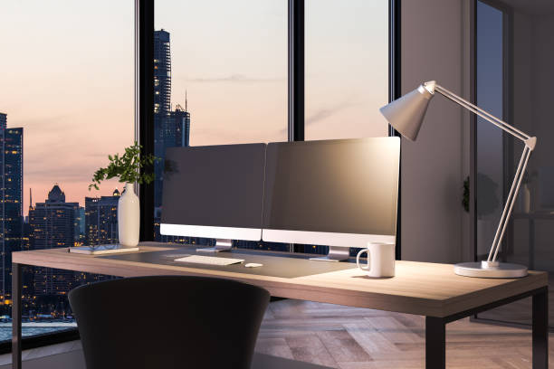 istock Two blank black computer screens on office desktop in interior with night city view. Corporate template. Mock up, 3D Rendering. 1328041942