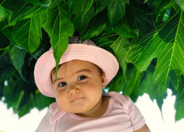 a two year old girl dressed for the sun
