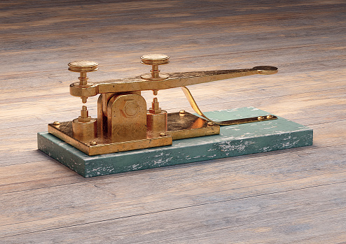 Antique electric telegraph machine isolated on wood table. 3D rendering