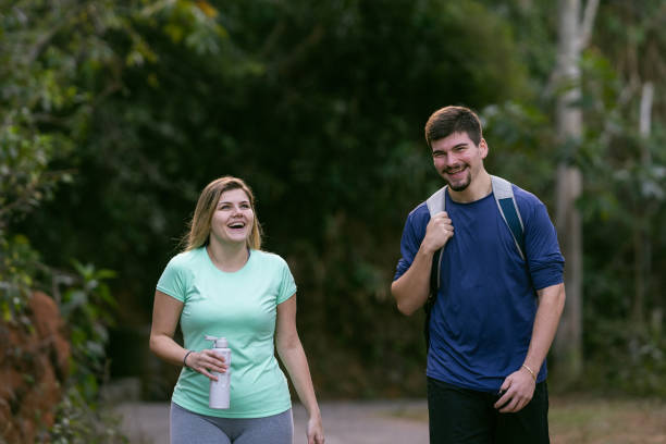 istock Athletes couple walking and smiling in the park 1328047866