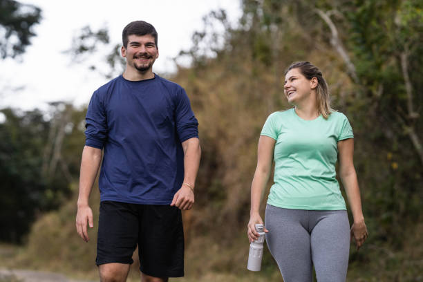 istock Smiling athletes walking calmly in the park 1328048785