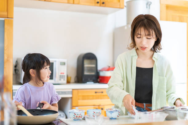 istock A little girl cooking with her mother 1328050302