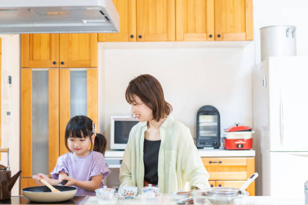 istock A little girl cooking with her mother 1328050304