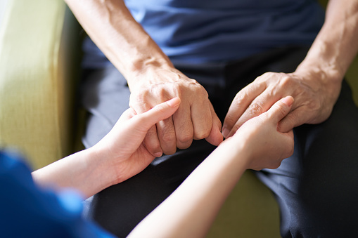 Hands of caregivers and the elderly