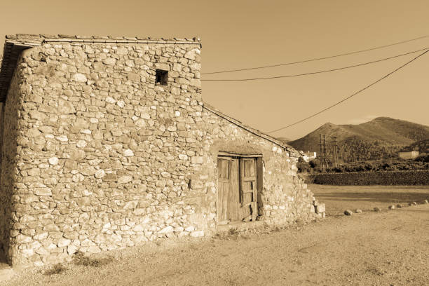 istock Old stone building with dilapidated wooden doors 1328059661