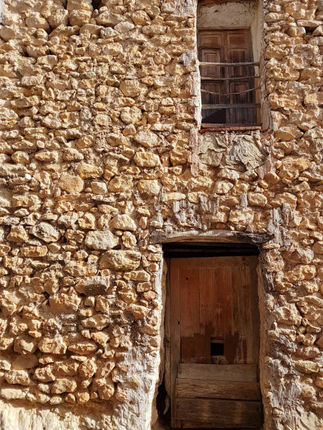 istock Wall of rocks with two old doors. 1328059694