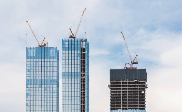 istock Construction site of skyscraper buildings and cranes against sky 1328059881