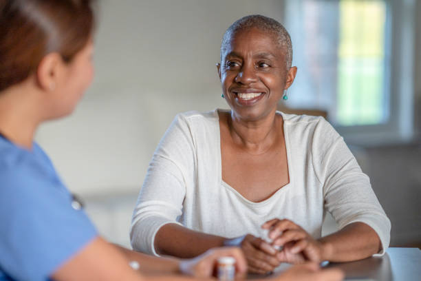 istock Cancer patient smiling while discussing with nurse 1328062455