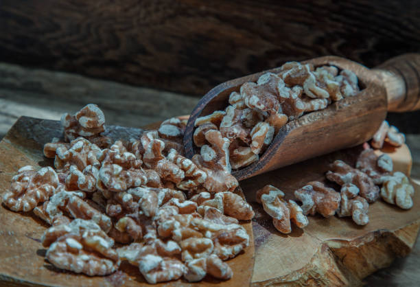 istock Pile of Walnuts kernels on old rustic wooden table. 1328064016