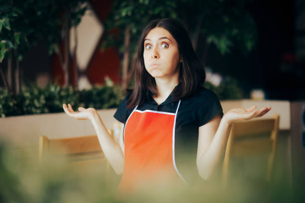 Clueless Puzzled Fast-Food Manager Standing in a Restaurant Worried stressed inexperienced worker failing first day at the job careless stock pictures, royalty-free photos & images