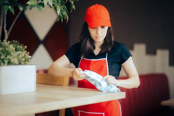 istock Fast Food Employee Cleaning Tables in a Restaurant 1328064141
