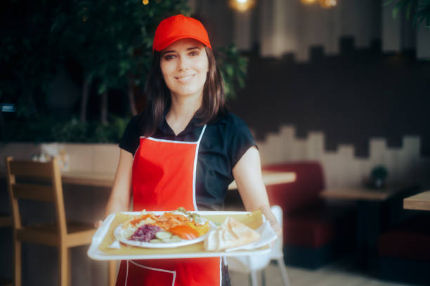 istock Happy Waitress Holding Food Tray Working in a Restaurant 1328064158