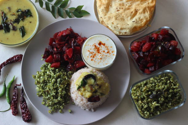 istock Vegetarian meals prepared in Kerala style. The serving includes boiled red rice, lentil curry, stir fried beetroot and potato, Stir fried French beans, curd and pappad. 1328069610