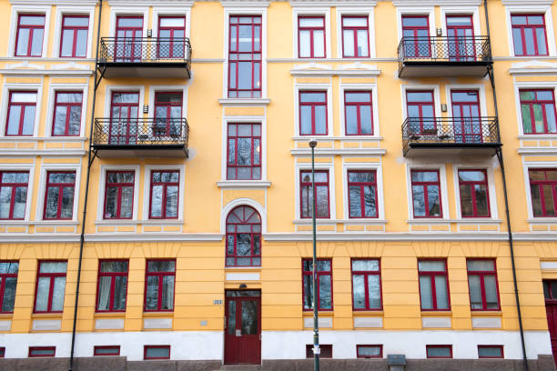 Facade of Colorful yellow Houses Buildings. Bright windows architecture.