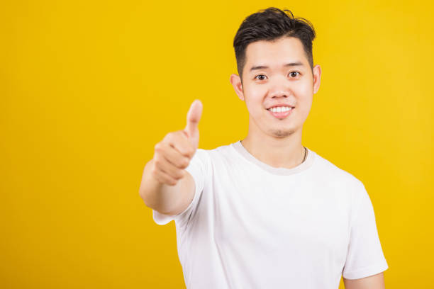istock man smiling positive showing thumbs up gesture 1328073255