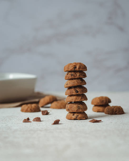 istock Tower of cookies with chocolate chips on a handmade rustic surface with pieces of chocolate 1328074138