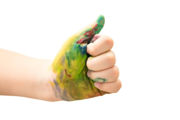 istock Child hand thumb up with multi colorful paint 1328074884