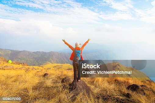 istock Hiker asian woman happy feeling freedom good and strong weight victorious facing on the natural mountain. Travel Concept 1328075100