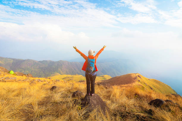 Hiker asian woman happy feeling freedom good and strong weight victorious facing on the natural mountain. Travel Concept Hiker asian woman happy feeling freedom good and strong weight victorious facing on the natural mountain. Travel Concept adventure stock pictures, royalty-free photos & images