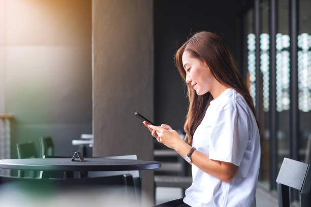 istock A beautiful young asian woman holding and using mobile phone 1328081792