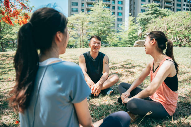 istock Young team sitting in the park and chatting after exercising 1328082364