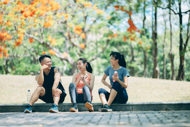istock Young team sitting in the park and chatting after exercising 1328082510