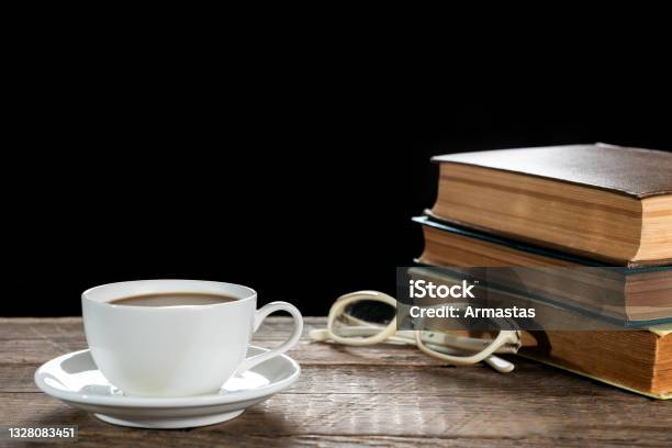 Cup Of Coffee And Old Books On A Wooden Table Stock Photo - Download Image Now - Book, Latte, Cafe