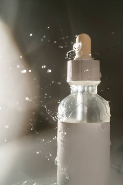 istock Cosmetic bottles with water splashes on a dark background. 1328089277