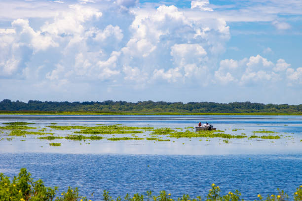istock People on a boat in a lake during a sunny and cloudy day 1328091466