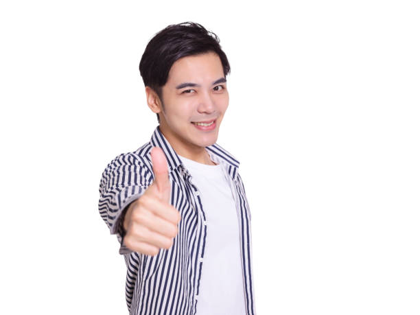 istock young man smiling and making thumbs up gesture 1328092059