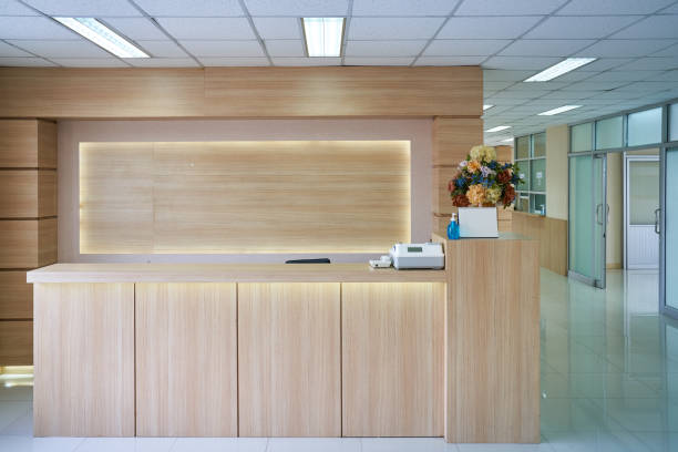 Empty lobby counter section in hospital healthcare background Empty lobby counter section in hospital healthcare background with clean and clear interior design medical office lobby stock pictures, royalty-free photos & images