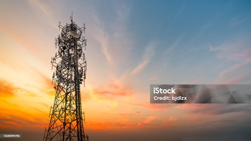 5G Sunset Cell Tower: Cellular communications tower for mobile phone and video data transmission 5G Stock Photo