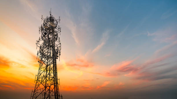 5G Sunset Cell Tower: Cellular communications tower for mobile phone and video data transmission 5G Sunset Cell Tower: Cellular communications tower for mobile phone and video data transmission transceiver stock pictures, royalty-free photos & images